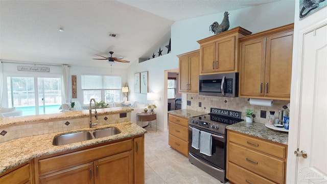 kitchen with stainless steel appliances, a sink, visible vents, and decorative backsplash