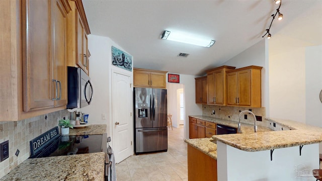 kitchen featuring a peninsula, visible vents, stainless steel fridge with ice dispenser, light stone countertops, and electric range oven