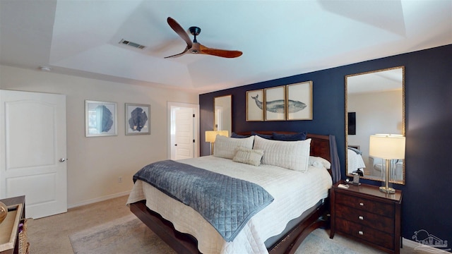 bedroom with visible vents, a raised ceiling, a ceiling fan, baseboards, and carpet