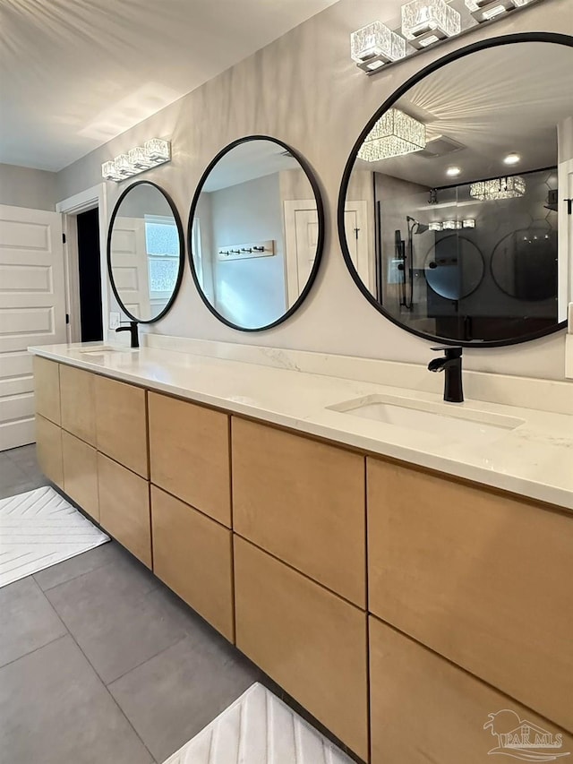 full bath with tile patterned flooring, walk in shower, a sink, and double vanity