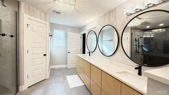 bathroom featuring double vanity, visible vents, a shower with door, tile patterned flooring, and a sink