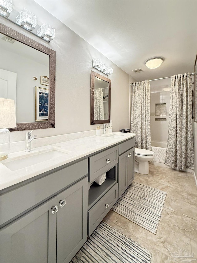 full bath featuring visible vents, shower / bath combination with curtain, a sink, and toilet