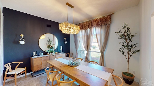 dining area with an inviting chandelier, visible vents, and baseboards