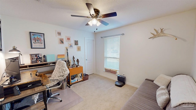 office area with carpet flooring, a ceiling fan, and baseboards