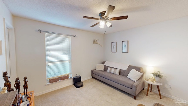 sitting room with baseboards, a textured ceiling, a ceiling fan, and carpet flooring