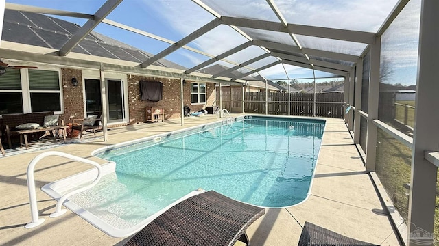 view of pool featuring a lanai, fence, a fenced in pool, and a patio