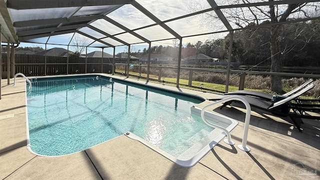 view of swimming pool featuring a patio, fence, a fenced in pool, and a lanai