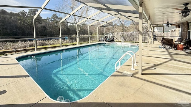 view of swimming pool featuring a fenced in pool, a patio, glass enclosure, ceiling fan, and fence