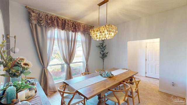 dining room featuring an inviting chandelier and baseboards