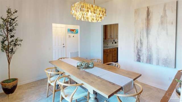 dining room with a chandelier, visible vents, and baseboards