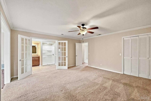 unfurnished bedroom with french doors, crown molding, light colored carpet, a textured ceiling, and ceiling fan