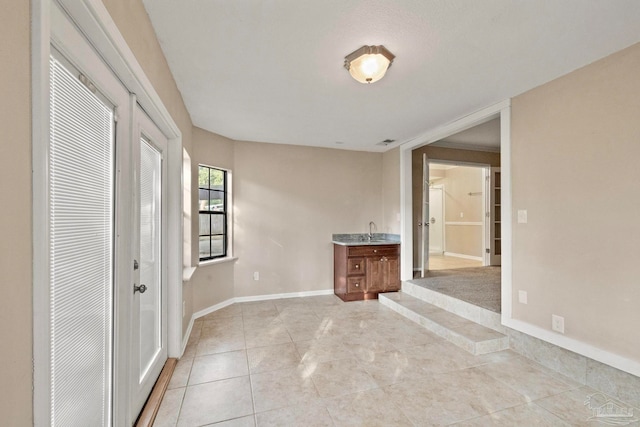 interior space featuring sink and light tile patterned floors