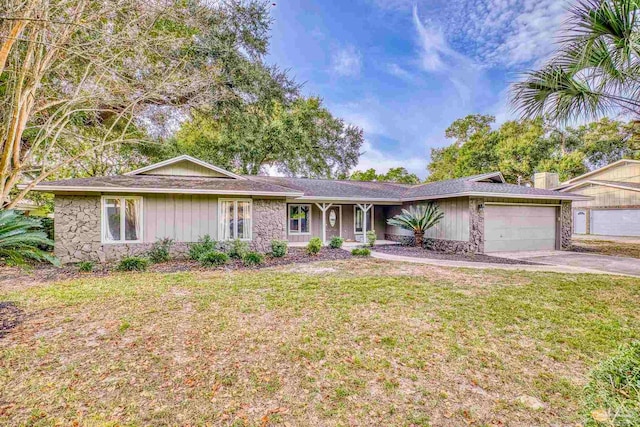 single story home with a front yard and a garage