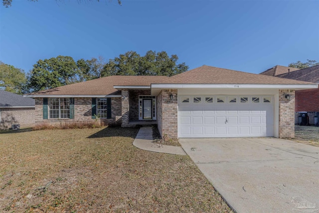 ranch-style house featuring an attached garage, driveway, a front lawn, and brick siding