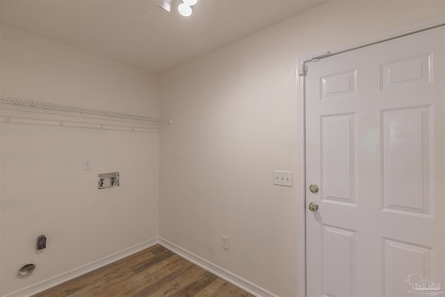 laundry area with laundry area, baseboards, washer hookup, and wood finished floors