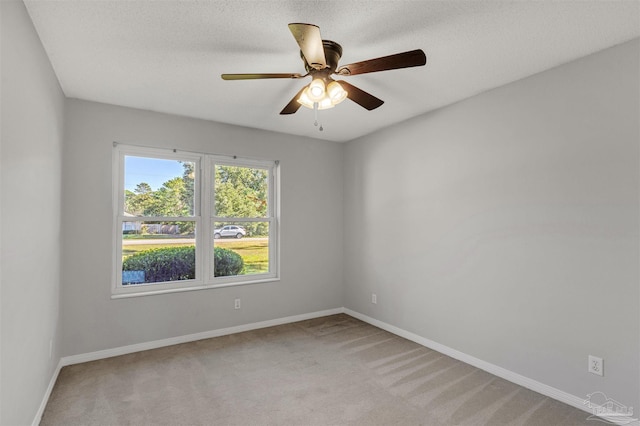 unfurnished room with light carpet, a textured ceiling, and ceiling fan