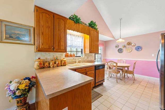 kitchen featuring vaulted ceiling, pendant lighting, decorative backsplash, sink, and paneled dishwasher