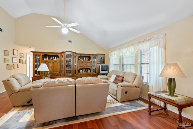 living room with ceiling fan, wood-type flooring, and high vaulted ceiling