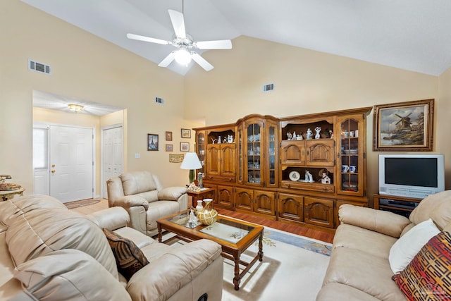 living room with ceiling fan, light hardwood / wood-style flooring, and high vaulted ceiling