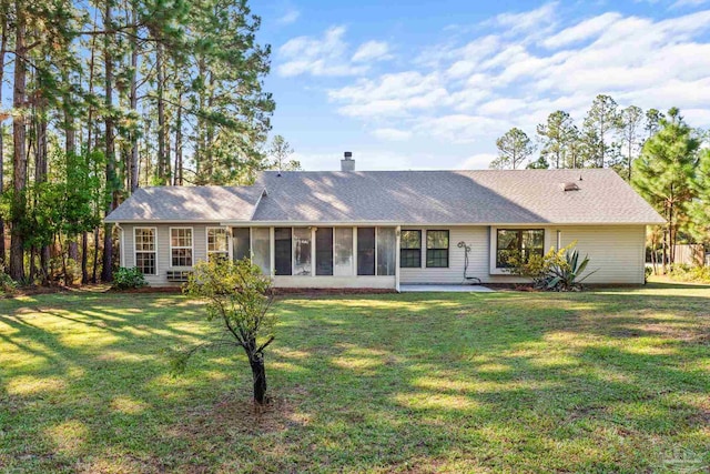 single story home featuring a patio area, a front lawn, and a sunroom