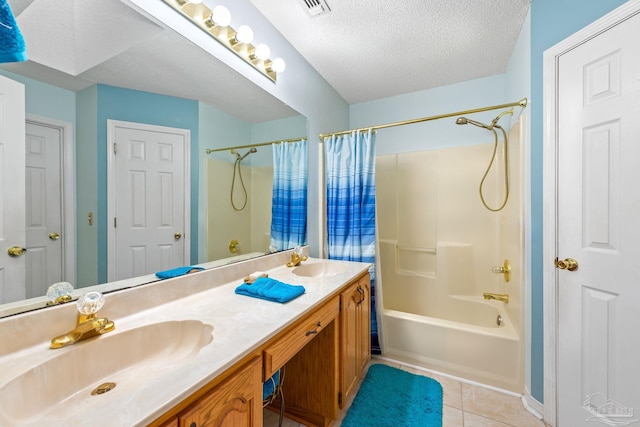 bathroom featuring a textured ceiling, tile patterned flooring, vanity, and shower / bath combo with shower curtain