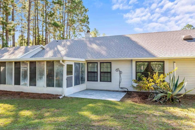 back of house with a patio area, a sunroom, and a yard