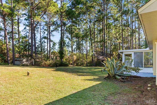 view of yard featuring a sunroom