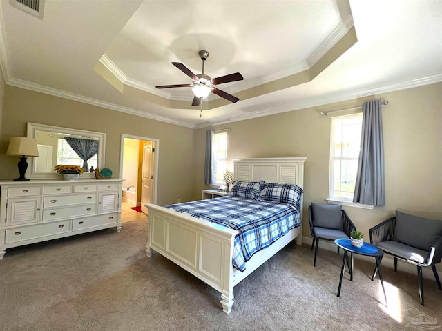 bedroom with a raised ceiling, multiple windows, crown molding, and carpet flooring