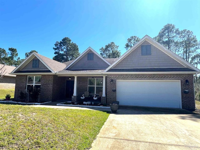 view of front of home featuring brick siding, concrete driveway, an attached garage, a front lawn, and covered porch