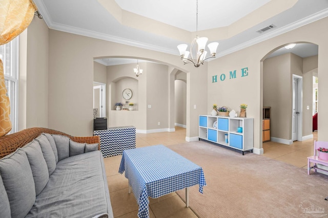living room with arched walkways, light tile patterned flooring, a chandelier, ornamental molding, and a tray ceiling