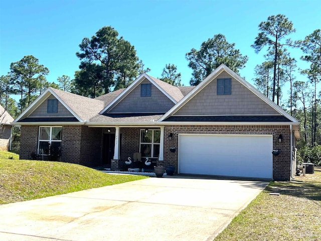 view of front of home featuring a garage, concrete driveway, brick siding, and a front yard