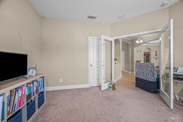 bedroom with arched walkways, carpet flooring, baseboards, and a chandelier