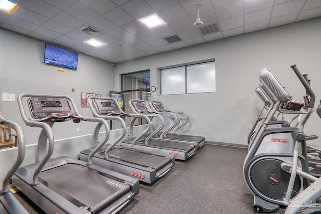 workout area featuring a paneled ceiling