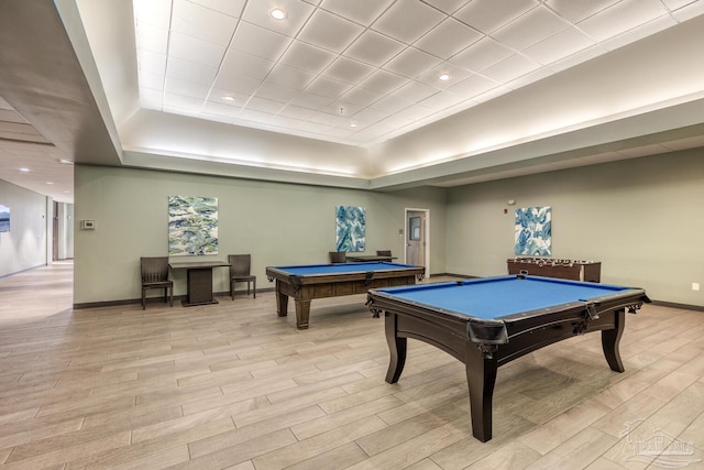 playroom with billiards table, baseboards, light wood-type flooring, recessed lighting, and a raised ceiling