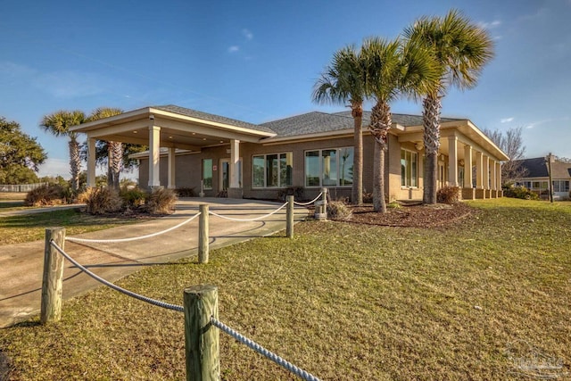 rear view of house featuring a lawn
