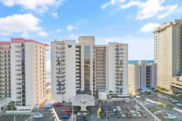 view of property featuring a view of city and uncovered parking