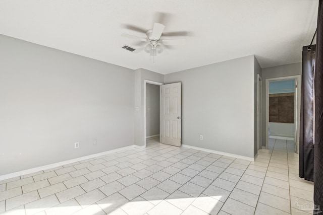 empty room featuring ceiling fan and light tile patterned floors