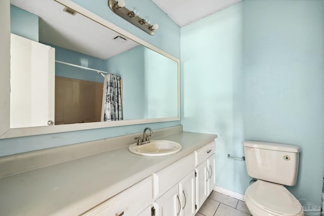 bathroom with tile patterned floors, vanity, curtained shower, and toilet