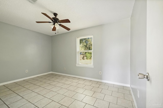 tiled empty room with a textured ceiling and ceiling fan