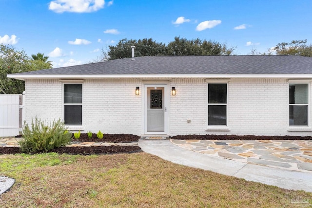 ranch-style home with a front lawn