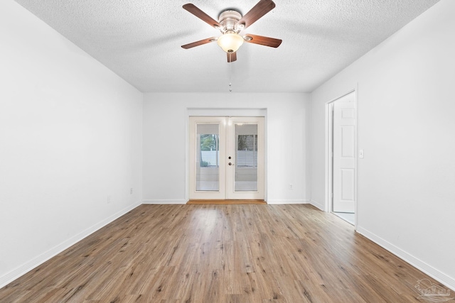 spare room featuring french doors, a textured ceiling, light hardwood / wood-style flooring, and ceiling fan