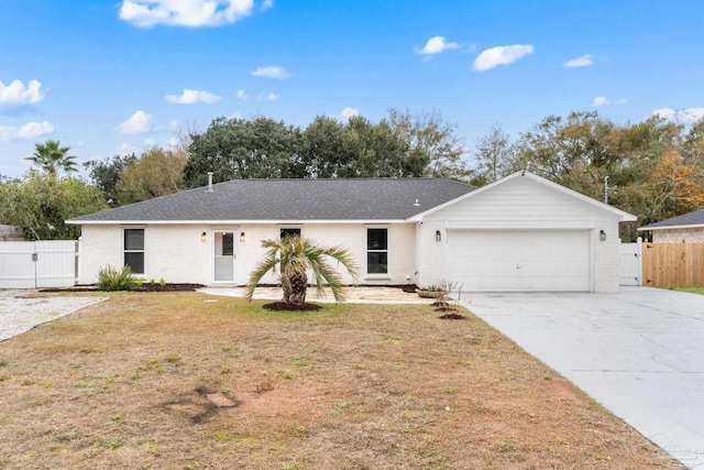 single story home with a front yard and a garage