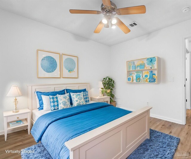 bedroom with ceiling fan and light hardwood / wood-style floors