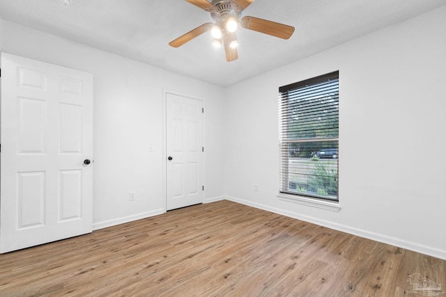 empty room featuring light hardwood / wood-style flooring and ceiling fan