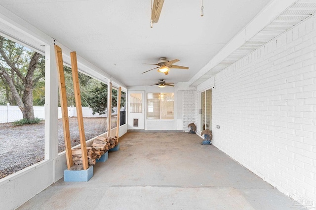 unfurnished sunroom with ceiling fan and a wealth of natural light