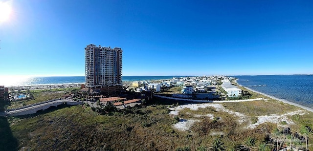 drone / aerial view featuring a water view and a view of the beach