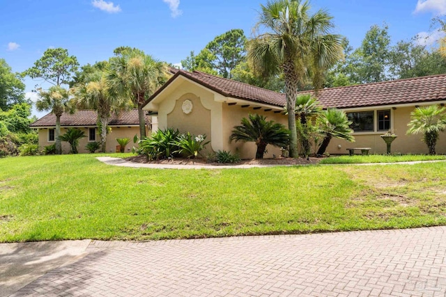 mediterranean / spanish house with a front lawn