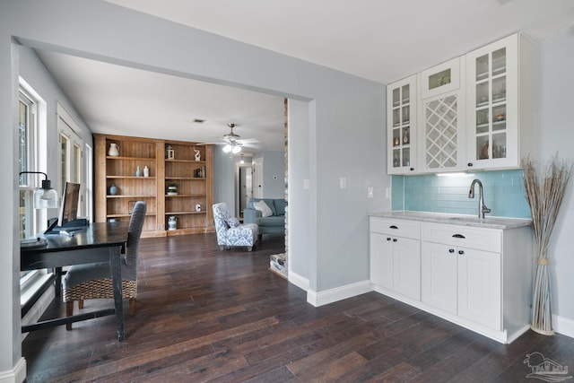 412 Deer Point Dr, Gulf Breeze, FL 32561 - interior space featuring baseboards, ceiling fan, wet bar, dark wood finished floors, and decorative backsplash