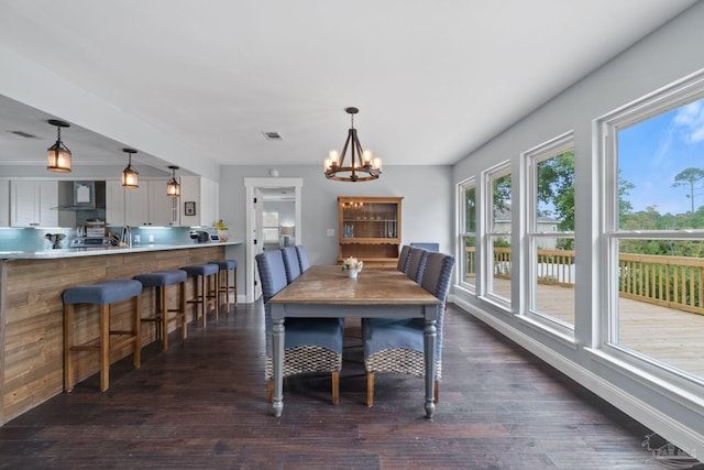 dining area featuring an inviting chandelier and dark hardwood / wood-style flooring