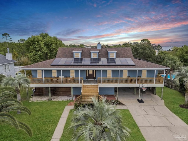 412 Deer Point Dr, Gulf Breeze, FL 32561 - back of property with a yard, a shingled roof, and concrete driveway